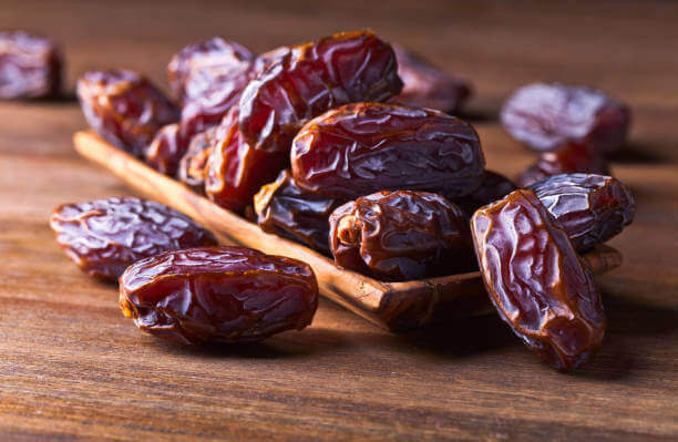 Sunnah Foods & Their Modern Health Benefits 2 Close-up of Medjool dates in a wooden bowl, a Sunnah superfood